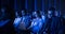 Female Sitting in a Dark Crowded Auditorium at a Tech Conference. Young Woman Using Laptop Computer