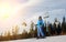 Female skier against ski-lift and forest on a sunny day