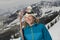 Female Skier Holding Skis On Mountain