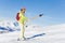 Female skier lifting on a button lift at sunny day