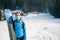 Female skier posing with a pait of skis wearing protective face mask.