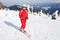 Female skier standing on mountain slope