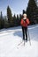 Female Snow Skiier Leaning on Poles and Smiling