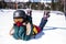 Female snowboarder lying on a snowy slope. Relax.