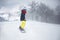 Female snowboarder on snowboard on mountain