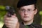 Female soldier targeting with a gun