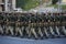 Female soldiers of a womens battalion marching with machine guns