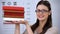 Female in spectacles showing books, oculist student preparing to become doctor