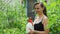 Female Spraying Tomato Plants with a Spray Bottle