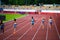 Female Sprinters in Full Stride during a 400m Race on the Athletics Track. Track and field illustration photo for Worlds in