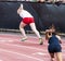 Female sprinters starting a race on a track