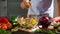 Female Squeezing Lemon Juice into Bowl with Salad