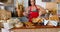 Female staff arranging bread on counter at bakery store