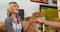 Female staff giving packed bread to woman at bakery section