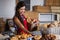 Female staff holding basket of sweet foods in bakery section