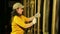 The female stage worker in gloves lifts the theater curtain and fastens the cable.