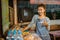 female stall keeper shows thumbs up while setting the table