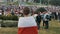 Female standing in front of camera during Protests in Belarus. People with apposition symbols and flags gathered for a