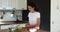 Female standing in kitchen preparing healthy vitamin summer salad