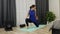 Female stretches hamstring muscles, leg muscles with pigeon pose. Young fit sporty brunette in pantone blue top, black leggings do