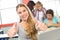 Female student gesturing thumbs up in classroom