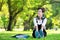 Female student girl outside in park listening to music on headphones while studying