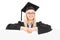 Female student in graduation gown posing behind blank panel
