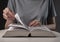 Female student hands close up, turning pages of thick book, searching for information and reading