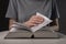 Female student hands close up, turning pages of thick book, searching for information and reading