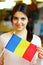 Female student holding flag of Romania