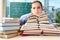 The female student with many books sitting in the classroom