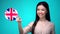 Female student pushing Great Britain flag button, ready to learn language