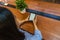 Female student reading ebook from tablet on wooden table