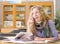 Female student reads the book in library