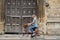 Female Student Riding Old Fashioned Bicycle Around Oxford University College Buildings With Motion Blur