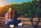 Female student sitting on wooden bench at campus