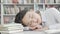 Female student sleeping on her desk after studying