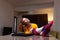 Female student studying on a laptop in living room. Girl stretching after finishing an online class. Home education concept