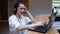 Female student uses a laptop and the Internet for training. A young woman in headphones