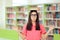 Female Student Writing an Essay Assignment in School Library