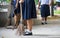 Female students help to sweep the concrete floor with a broom