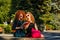 Female students read a book in park.