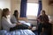 Female Students Relaxing In Bedroom Of Campus Accommodation