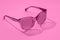 Female Sunglasses in beautiful fashion pink minimal concept. New 2022 trending PANTONE pink color
