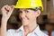 Female Supervisor Touching Hardhat At Warehouse