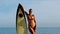 Female surfer leaning against her board