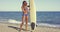 female surfer standing with her board