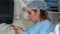 Female surgeon reading message at mobile phone