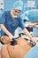 Female surgeon resuscitating an unconscious patient with a defibrillator