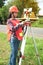 Female Surveyor or Engineer setting measure prism reflector on the street.